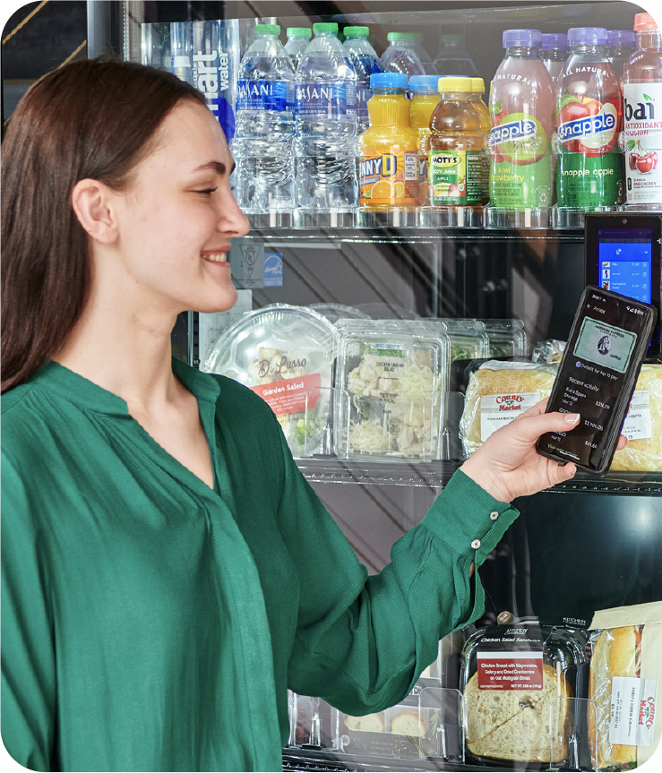 school-main Woman purchasing from a vending machine from her phone